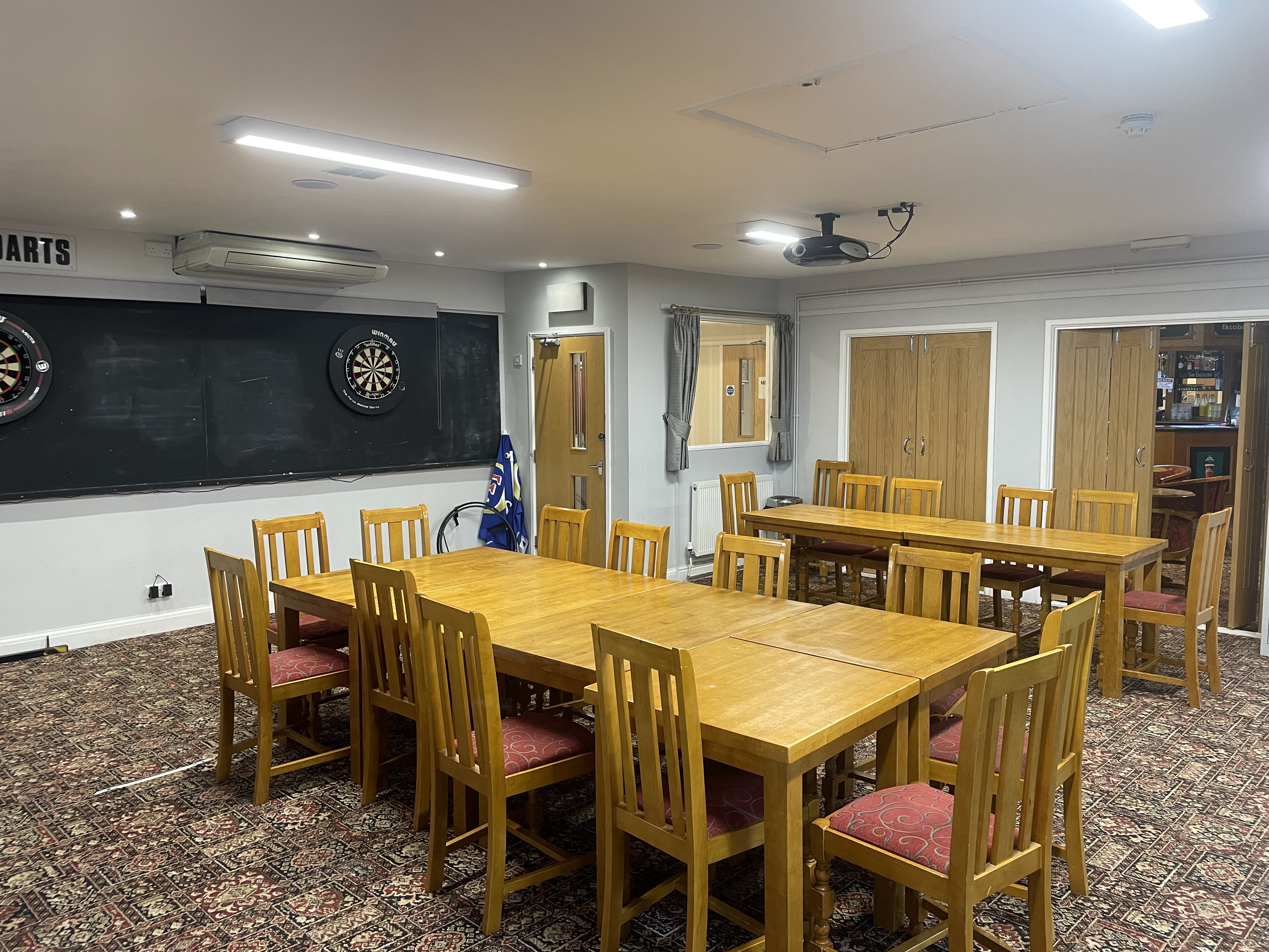 Tables and seating arranged inside the Sports Room